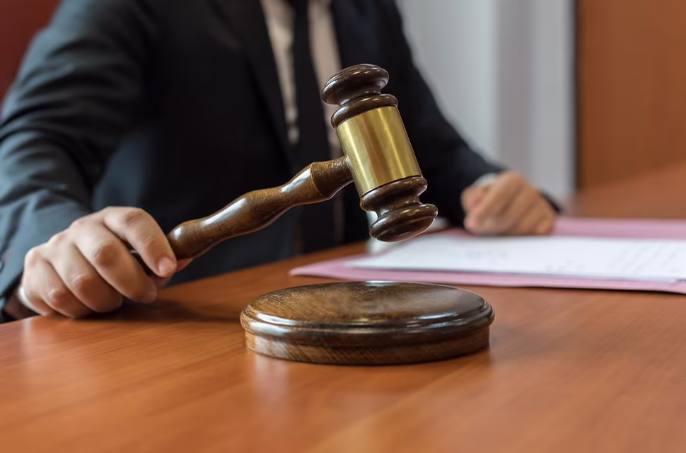 Man in a suit using a gavel